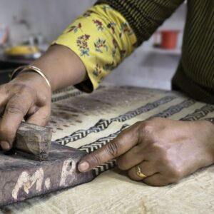 Artisan hand block printing on cotton fabric during a traditional Bagru workshop near Jaipur